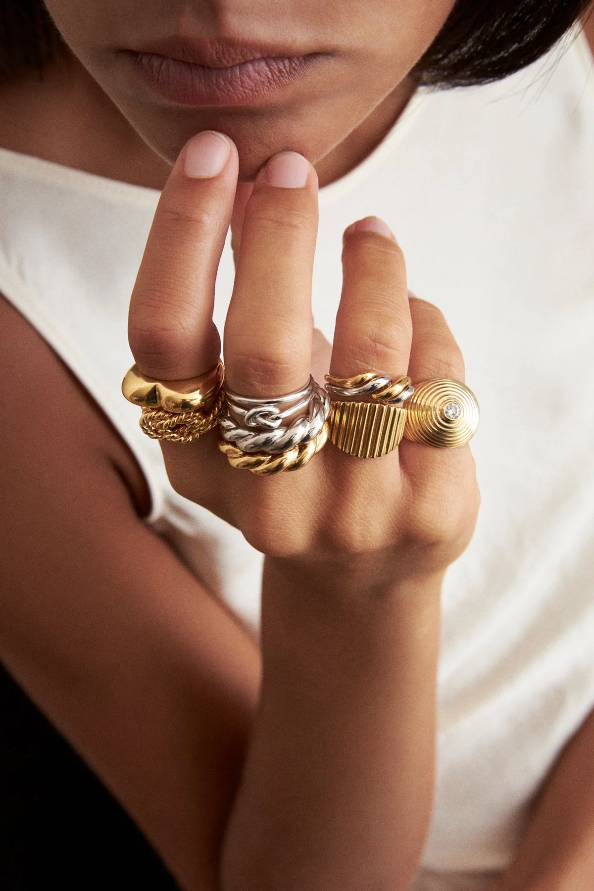 stacking ring styling ideas with silver and gold rings on fingers