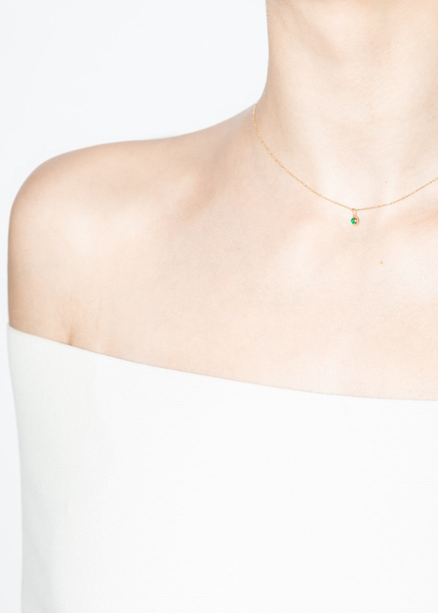 model wearing mock necklace emerald 18k