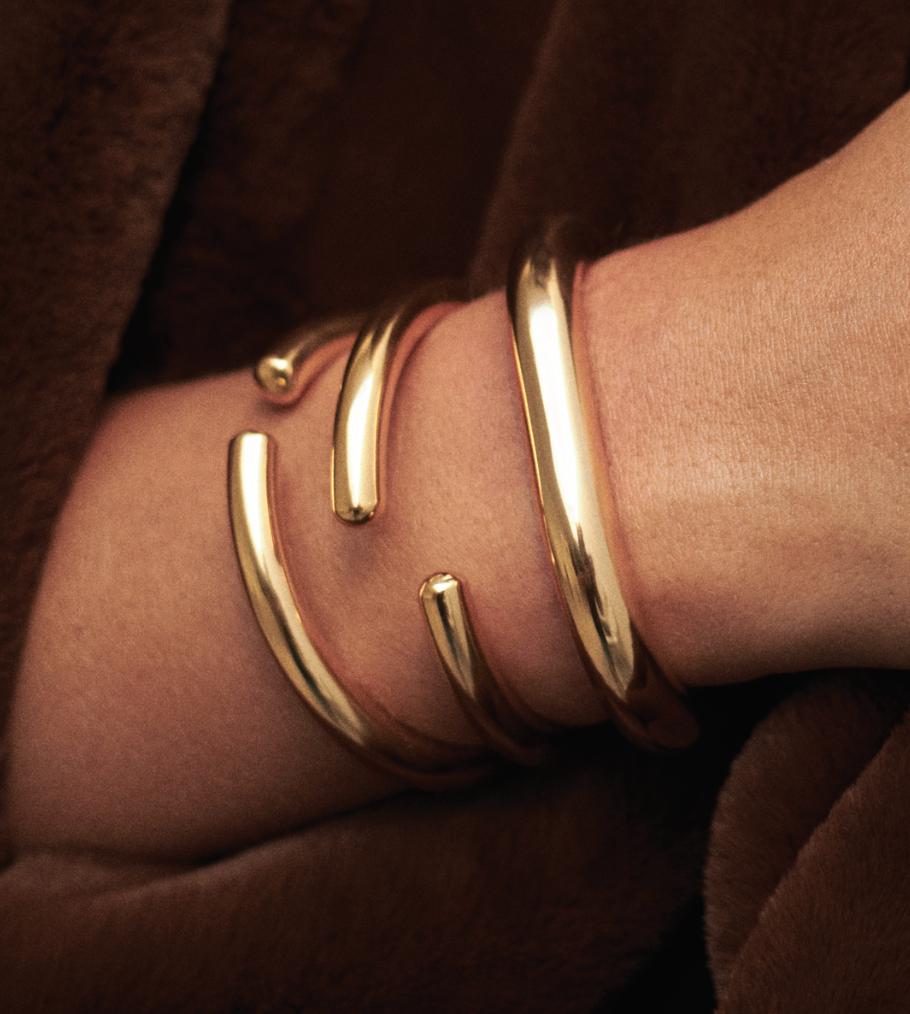 Stylish gold bracelets stacked on a wrist, perfect for daily wear with silver bracelets for women.