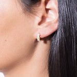 model wearing shaped diamond earrings 18k