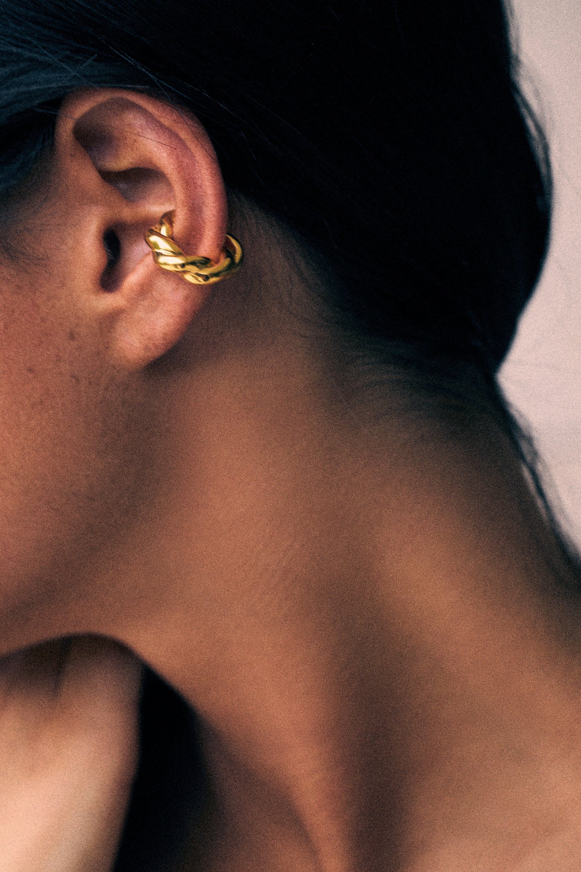 model wearing monet earcuff in gold