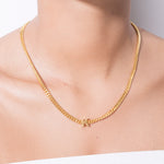 model wearing alphabet necklace with pendant K in gold