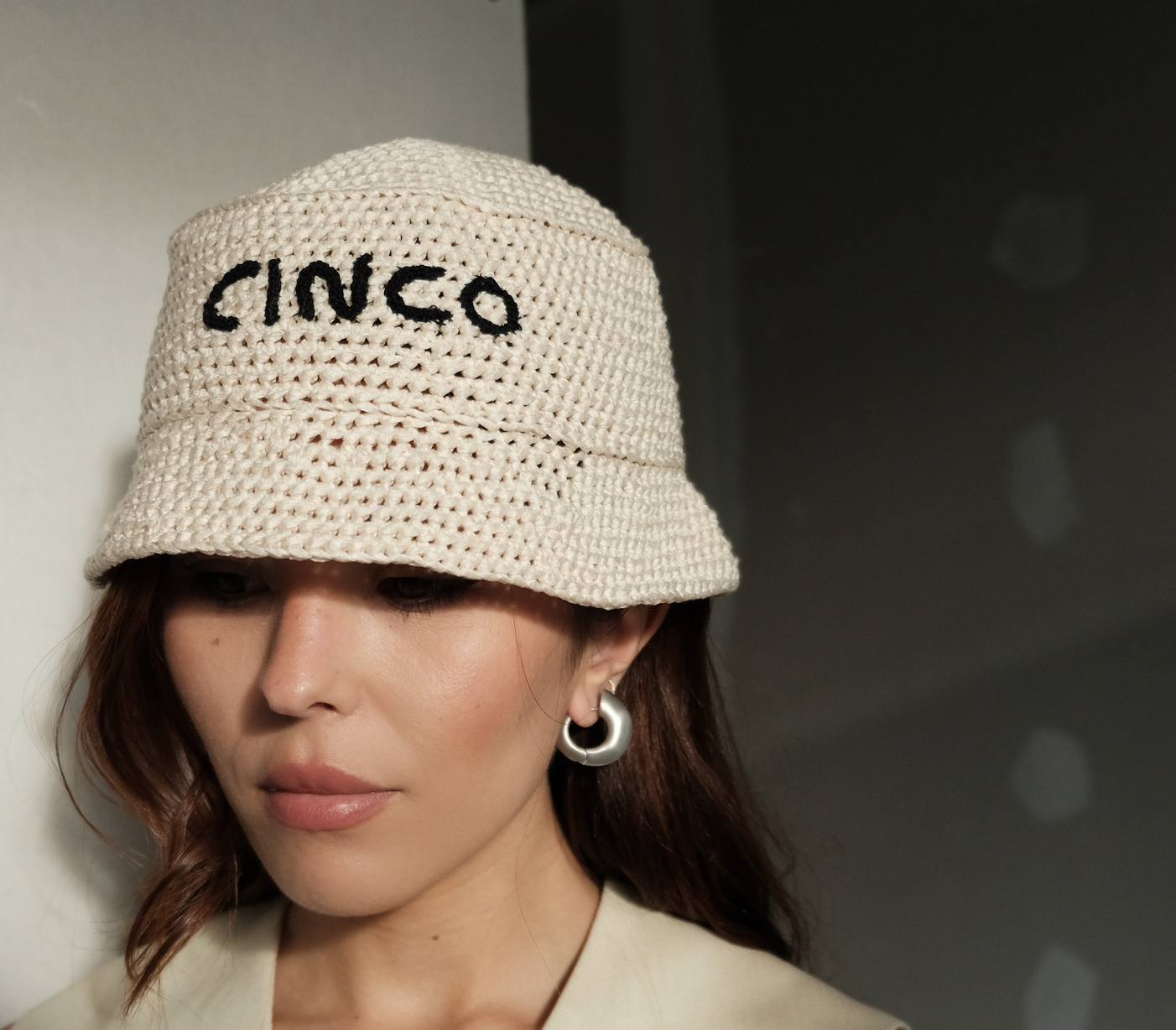 model wearing crochet hat and sara earrings in silver