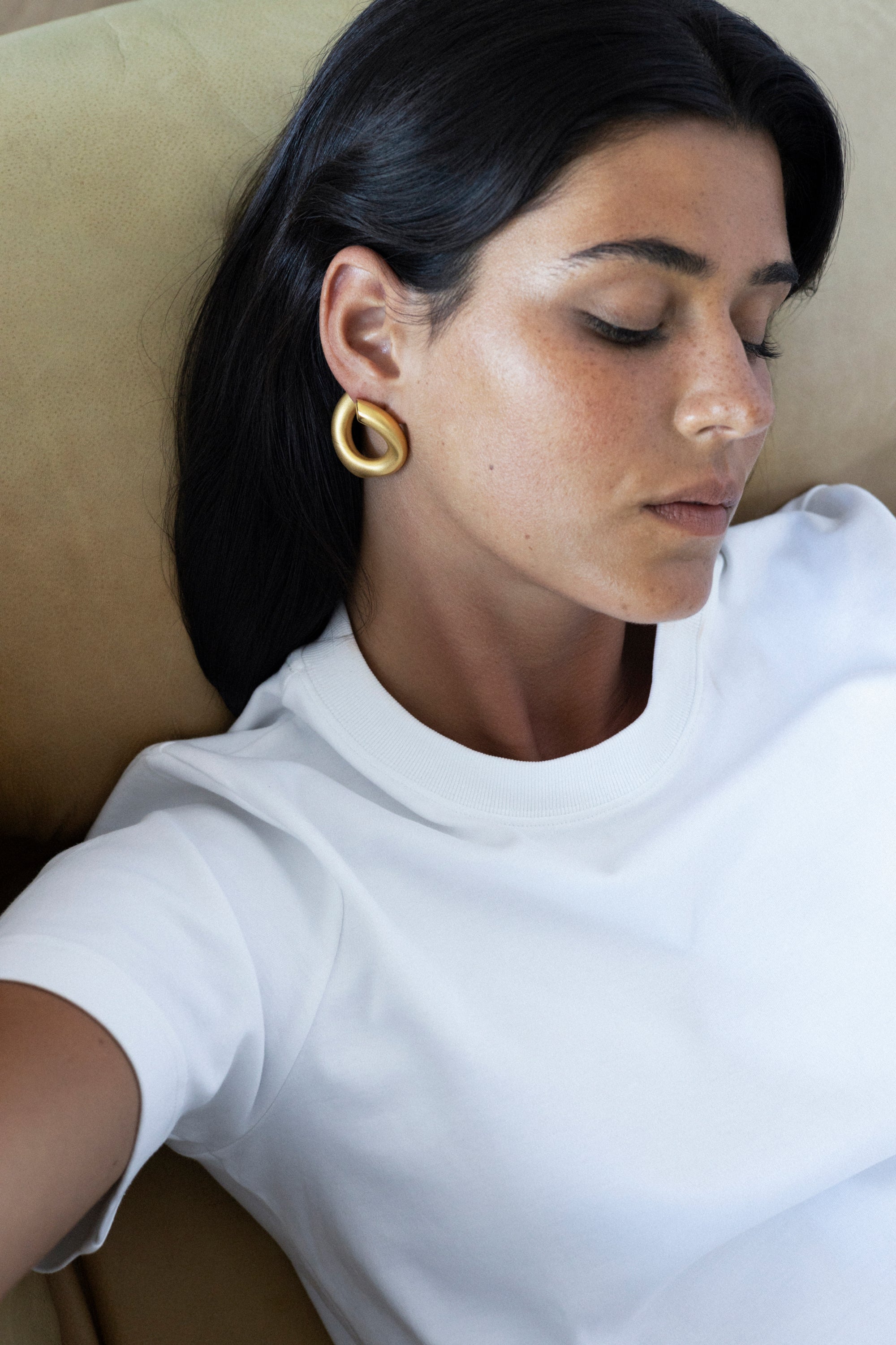 model wearing claudine earrings in gold