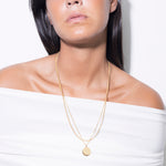 model wearing flo necklace and madeleine necklace in gold