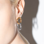 model wearing gilda two tone earrings