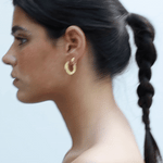 video of model wearing maxi jodie earrings and jodie huggies in gold