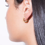 model wearing heptagon huggies 18k