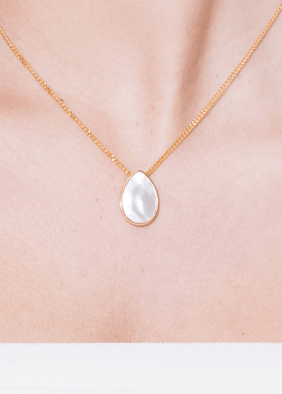 Klein Pearl Double Side Necklace with a pear-shaped pearl pendant on a delicate gold chain.
