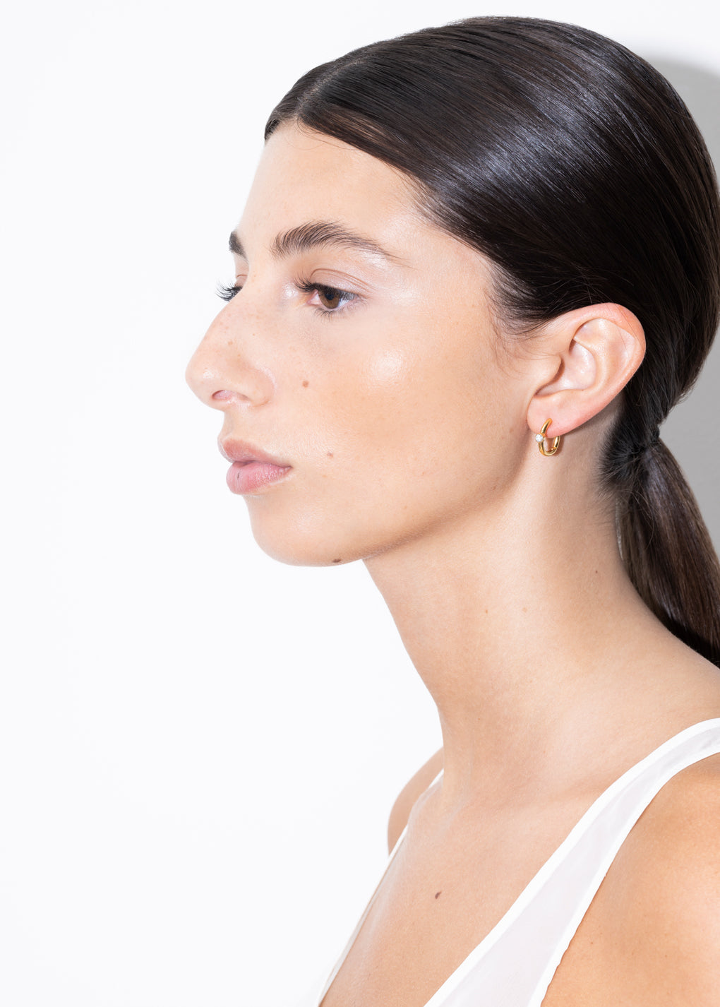 model wearing linda earrings in gold