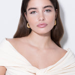 model wearing magda earrings in gold