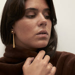 model wearing sade earrings in gold