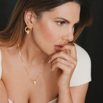 model wearing nina earrings, nina necklace and eden bracelet in gold