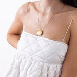 model wearing daisy necklace in gold