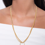 model wearing pilar necklace and flo necklace in gold